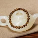 Natural Hainan agarwood bracelet showing tonal variation and hand-polished finish